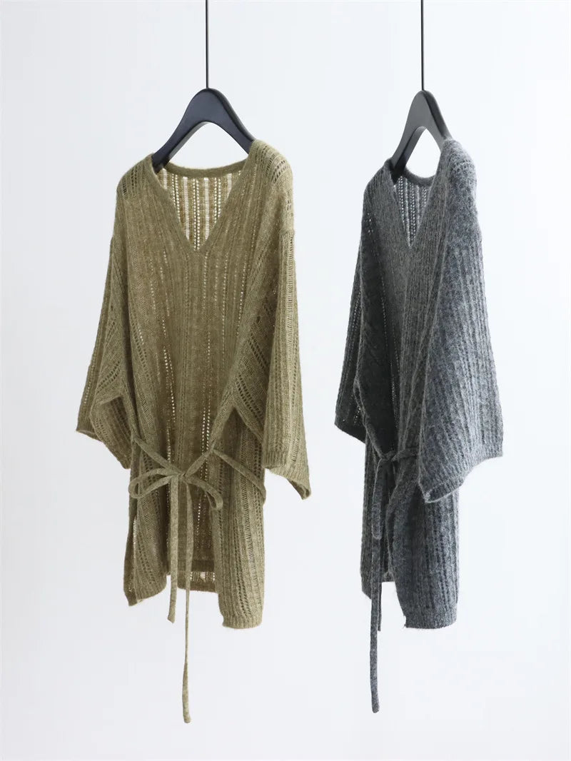 Lazy three-quarter sleeve knitted sweater with V-neck, belt at the waist, pullover style coat. Stylish autumn-winter top for wom