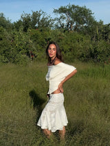 With Jen Off-the-Shoulder Black T-Shirt With a Round Neckline and a Fitted Waist, Featuring an Irregular Cut and Short Sleeves.