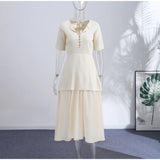 Crew Neck Short Sleeve Buttoned Paneled Midi Dress Fitted Bodice Flowing 2026 Spring Women Knit Skirt Fashion Elegant Lady Gown
