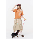 ELFSACK Orange Off Shoulder T-shirt, Loose Graffiti Print V-neck Tee, Casual Y2K Letter Graphic Top for Women