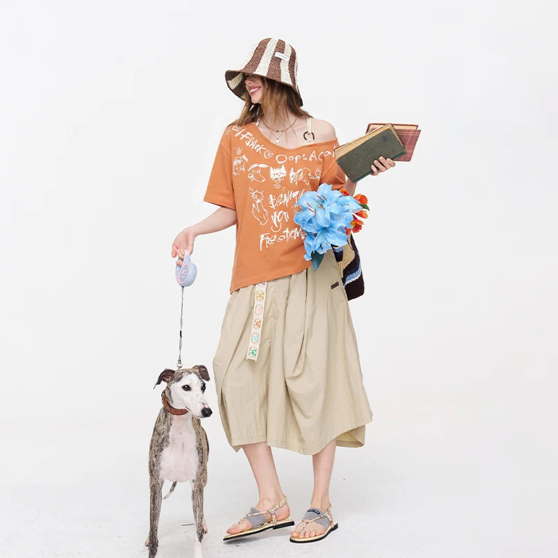 ELFSACK Orange Off Shoulder T-shirt, Loose Graffiti Print V-neck Tee, Casual Y2K Letter Graphic Top for Women